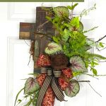 red, black, and tan bow, cross, greenery