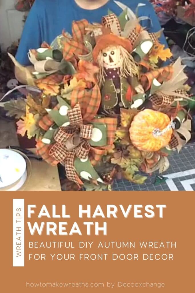 fall colored bow, pumpkin stems, and stuff scarecrow on a wreath