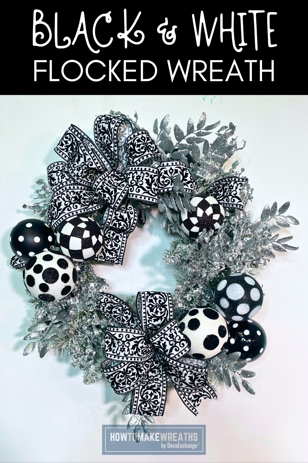 black and white winter wreath with ornaments and silver greenery