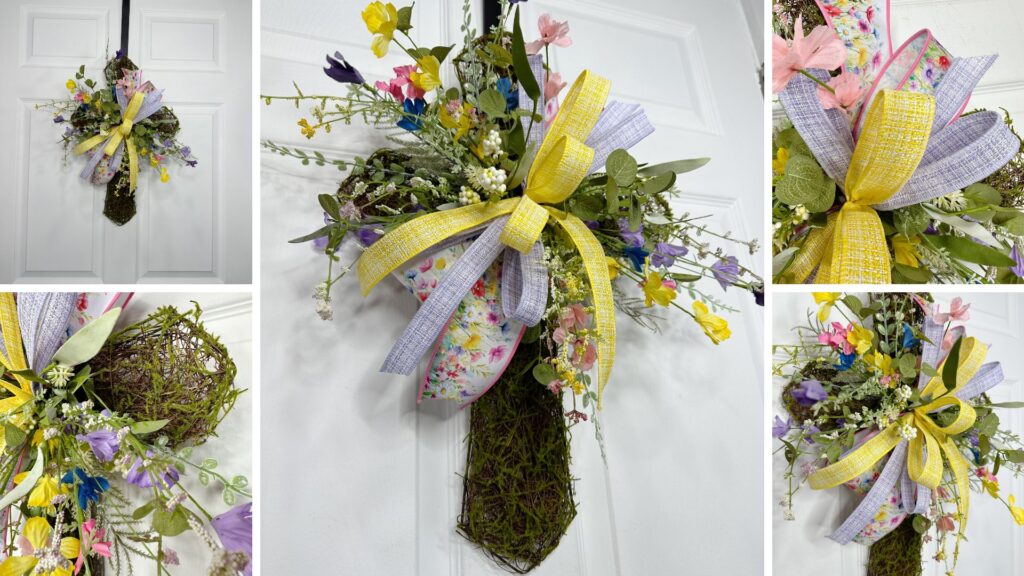 Spring vine cross wreath on a white door featuring pastel faux florals, moss covered vine base, and a layered yellow and lavender ribbon bow.