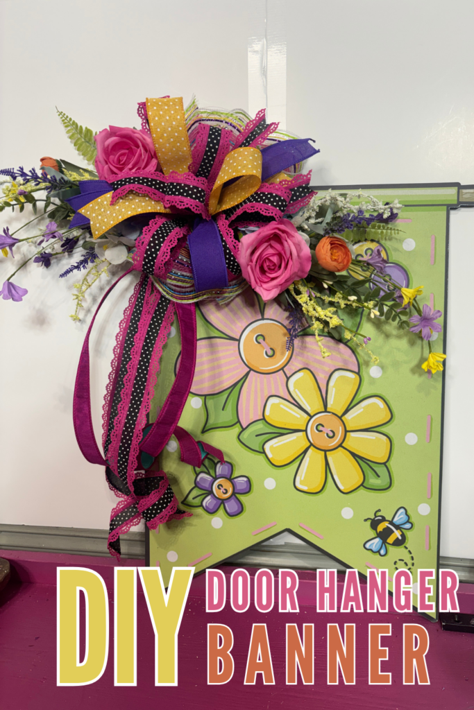 handmade spring door hanger with layered mesh, purple ribbon, polka dot ribbon, and floral picks creating a colorful front door decoration