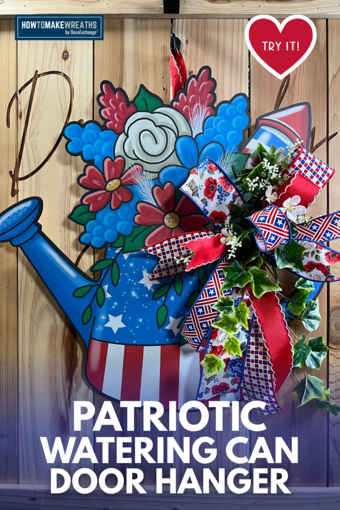 Patriotic watering can door hanger with red white and blue ribbon bow greenery and florals for 4th of July front door decor