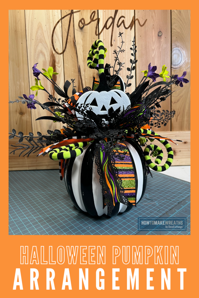 Foam based Halloween arrangement with faux florals and picks.