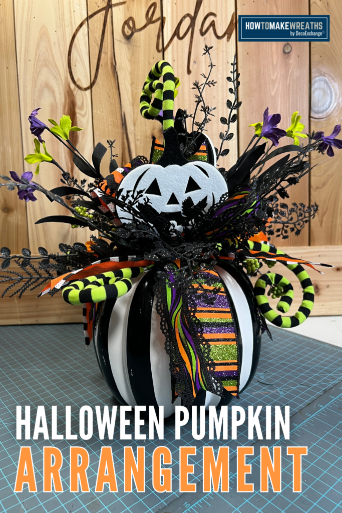 Foam based Halloween arrangement with faux florals and picks.