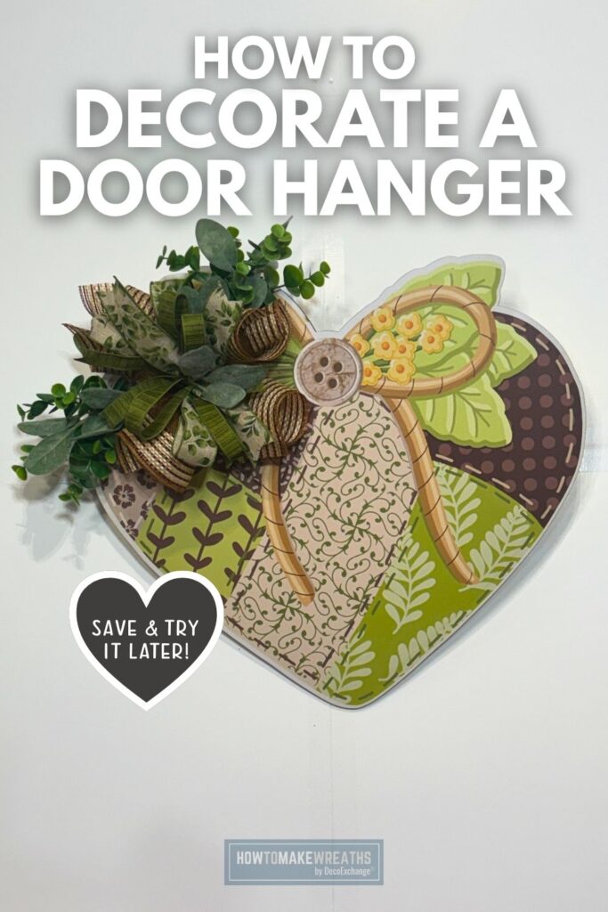 Heart-shaped door hanger with a green and brown patchwork print, decorated on the left side with brown mesh, olive and floral ribbon loops, and greenery stems including eucalyptus and ivy. The piece hangs on a white door. Text overlay reads How to Decorate a Door Hanger. A heart icon in the lower left reads Save and Try It Later. HowToMakeWreaths by DecoExchange logo at the bottom.