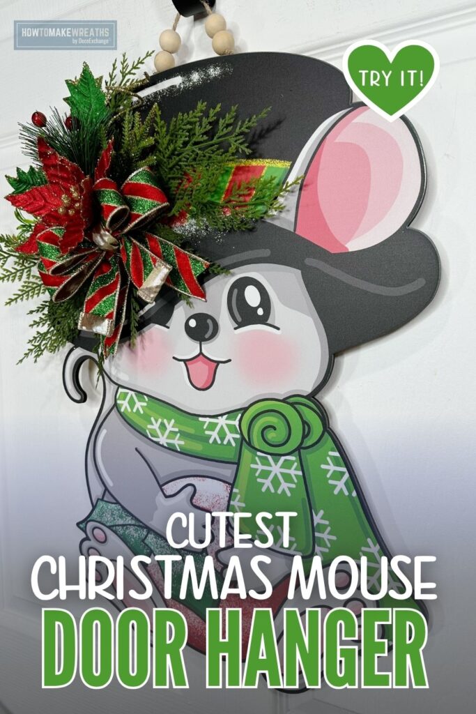 Christmas mouse door hanger with an added floral, greenery, and bow embellishment.